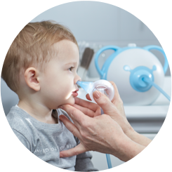 An ENT doctor clearing a boy's nose with the help of a safe baby nasal aspirator Nosiboo Pro