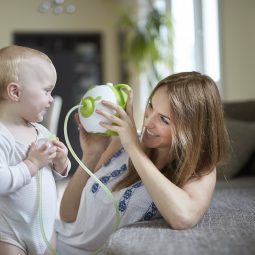 A little baby boy and his mother with the innovative Nosiboo Pro Electric Nasal Aspirator